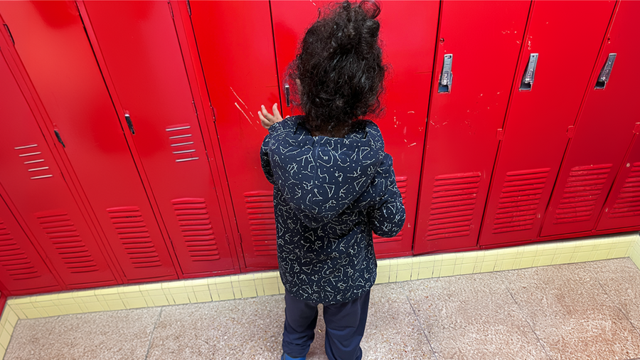 Autistic child in sensory hoodie at school to help regulate.