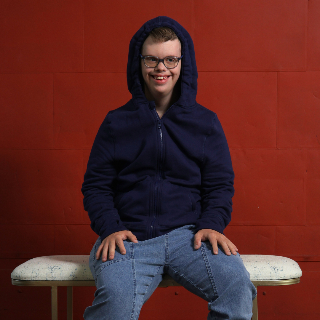 man with disabilities wearing a sensory hoodie with sound reducing hood pulled up.