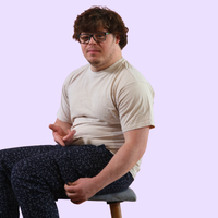 Man with down syndrome showing off magnetic fidget pocket on sensory pants. 