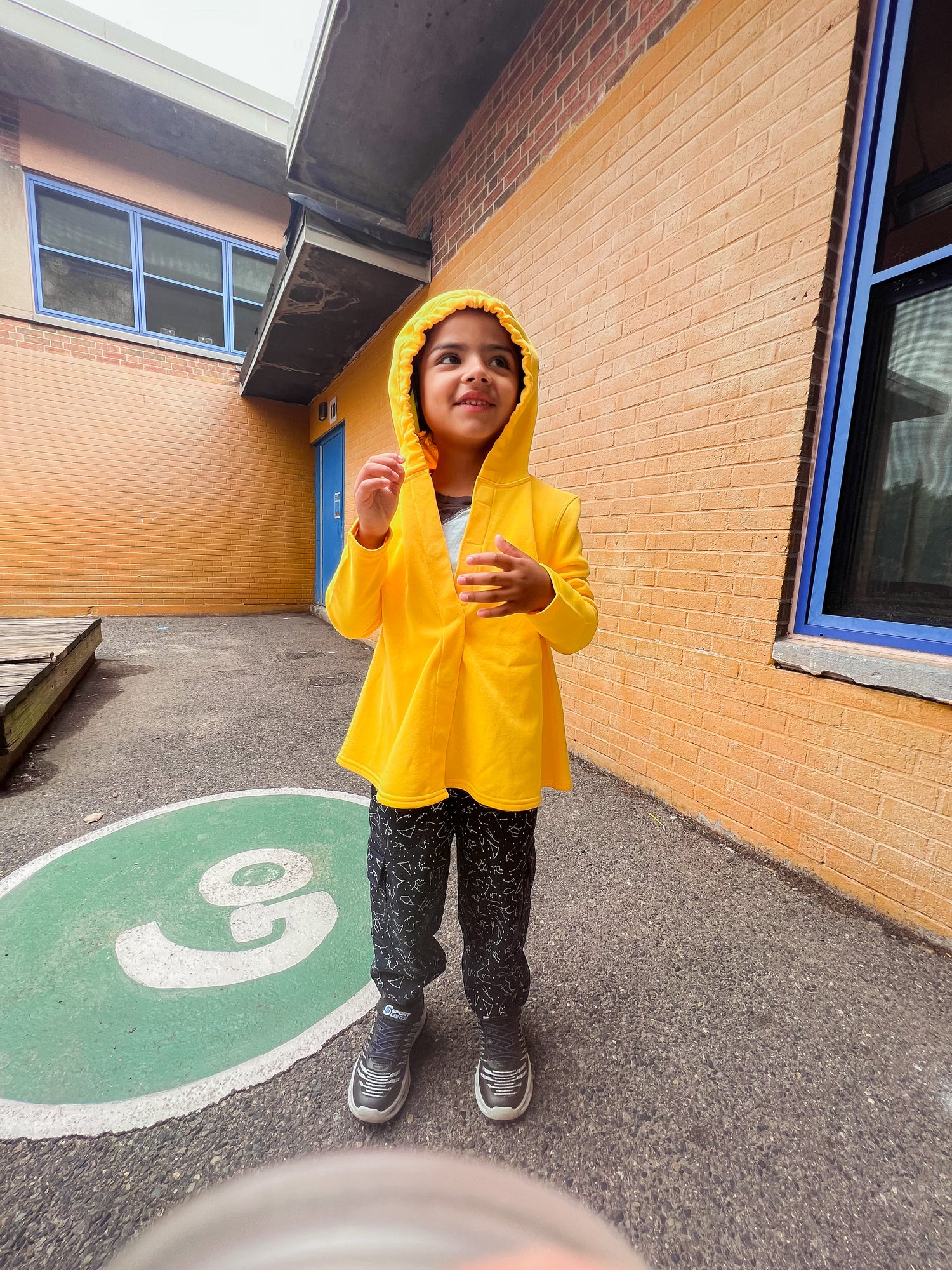 Autistic boy in sensory friendly hoodie, sensory pants, and a compression vest shirt.