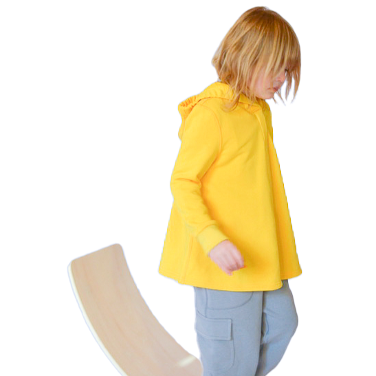 Autistic girl on balance board wearing sensory friendly hoodie and sensory friendly pants